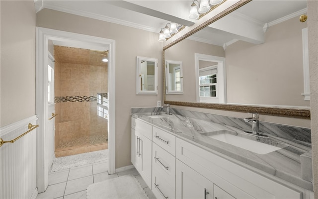 bathroom featuring tile patterned floors, vanity, ornamental molding, and tiled shower