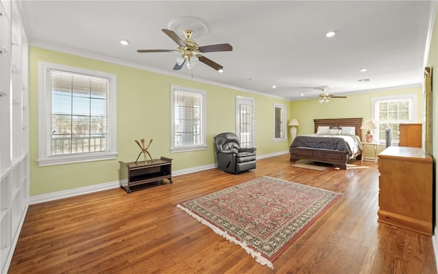 bedroom with ceiling fan, crown molding, and hardwood / wood-style flooring