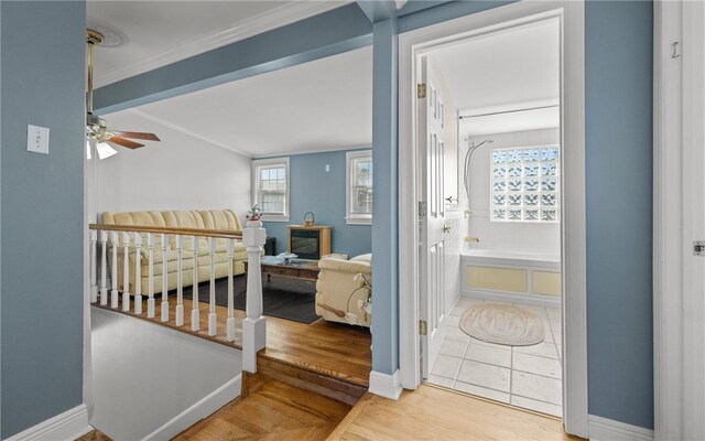 bedroom with hardwood / wood-style floors, ceiling fan, and ornamental molding