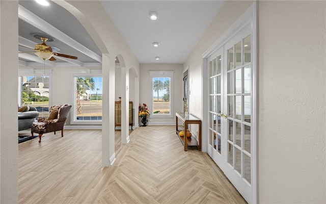 hall with french doors and a healthy amount of sunlight