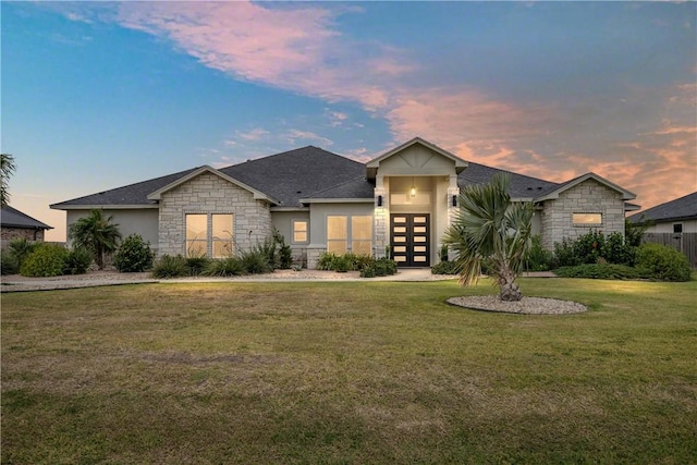 view of front of home with a yard and french doors