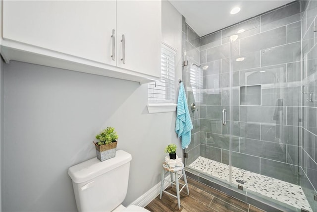 bathroom featuring an enclosed shower and toilet