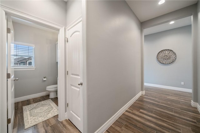 bathroom with toilet and hardwood / wood-style flooring