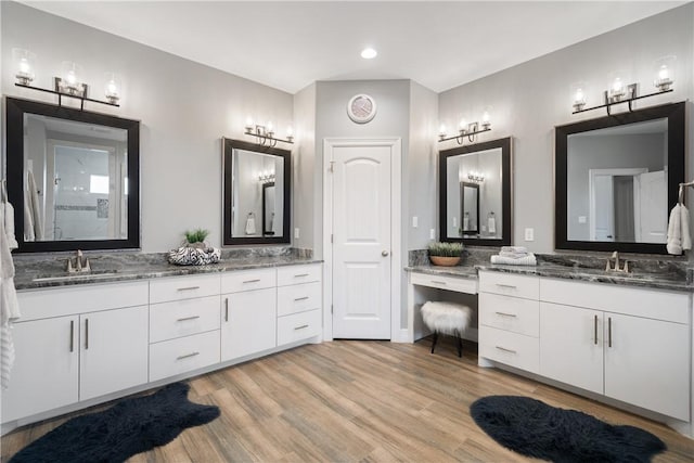 bathroom with hardwood / wood-style floors and vanity