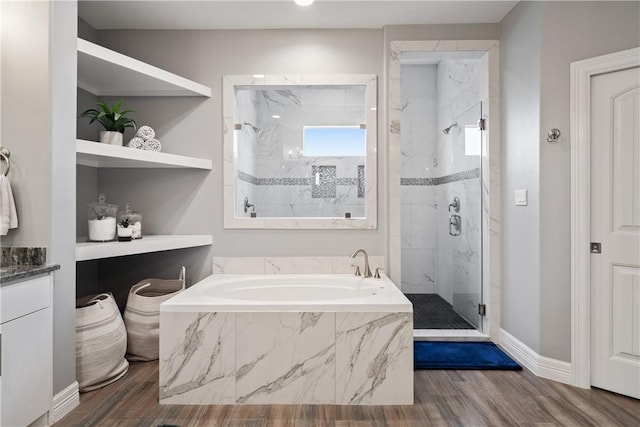 bathroom with shower with separate bathtub and wood-type flooring