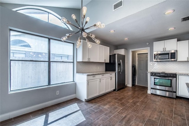 kitchen featuring visible vents, decorative backsplash, white cabinetry, a chandelier, and stainless steel appliances