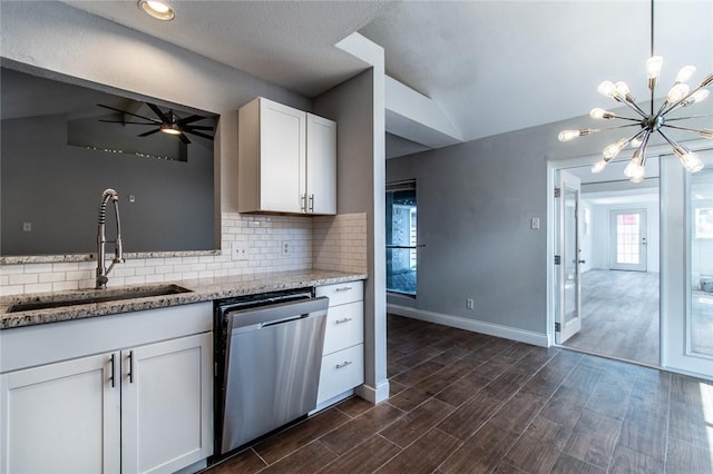 kitchen featuring a sink, tasteful backsplash, stainless steel dishwasher, vaulted ceiling, and dark wood-style floors