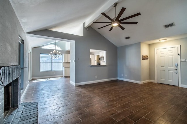 unfurnished living room featuring visible vents, a brick fireplace, beam ceiling, high vaulted ceiling, and ceiling fan with notable chandelier