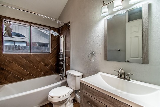 bathroom with toilet, a textured wall, shower / bathing tub combination, and vanity