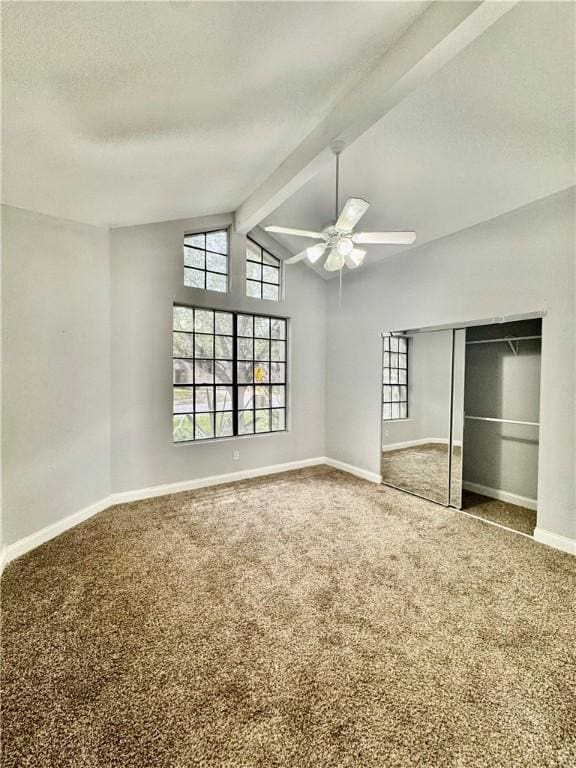 unfurnished bedroom with a ceiling fan, baseboards, a closet, vaulted ceiling with beams, and carpet flooring