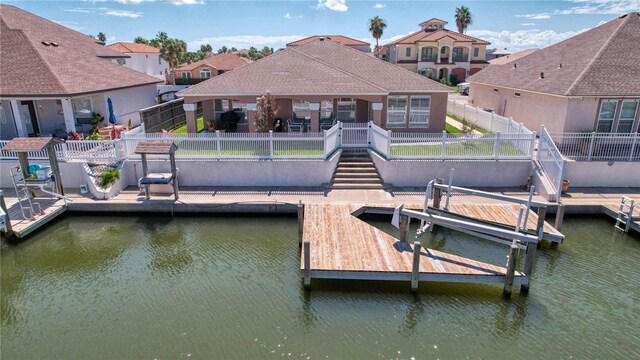 dock area with a water view and a patio area