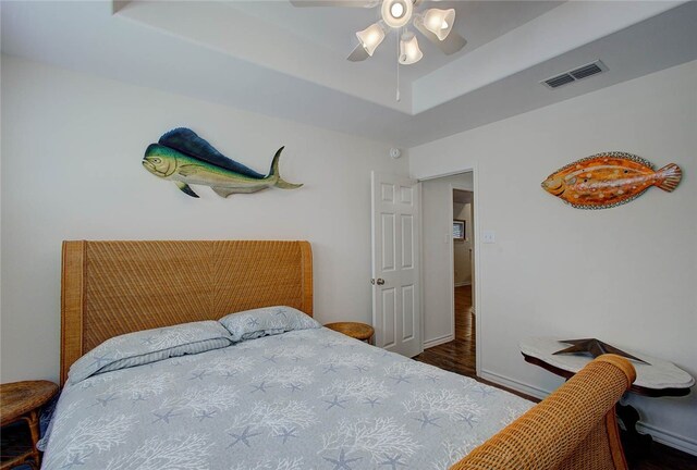 bedroom featuring ceiling fan and dark hardwood / wood-style flooring