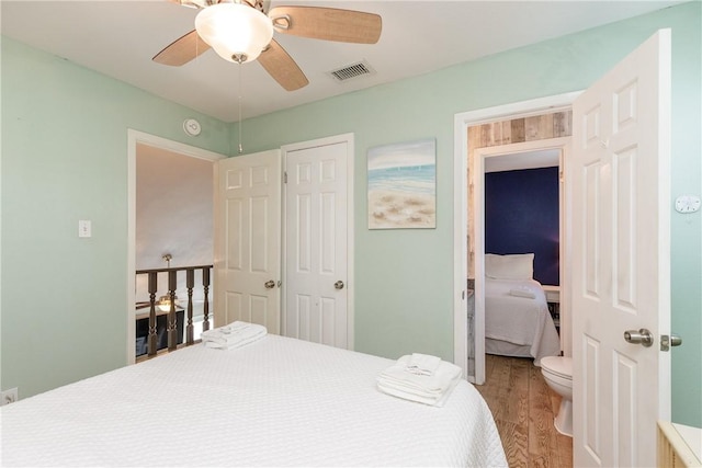 bedroom with visible vents, ceiling fan, and wood finished floors