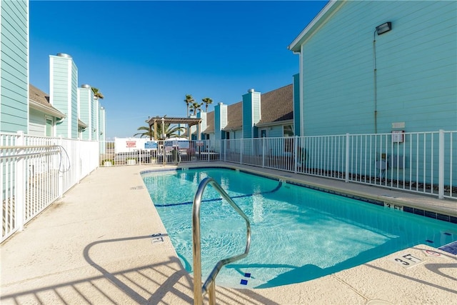 community pool featuring a patio and fence