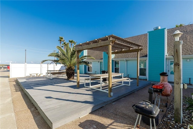 view of patio with grilling area, fence, and a pergola