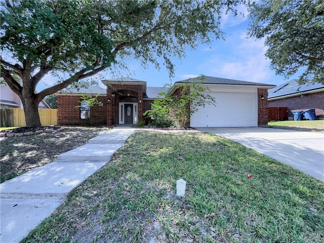 ranch-style house with a garage and a front yard