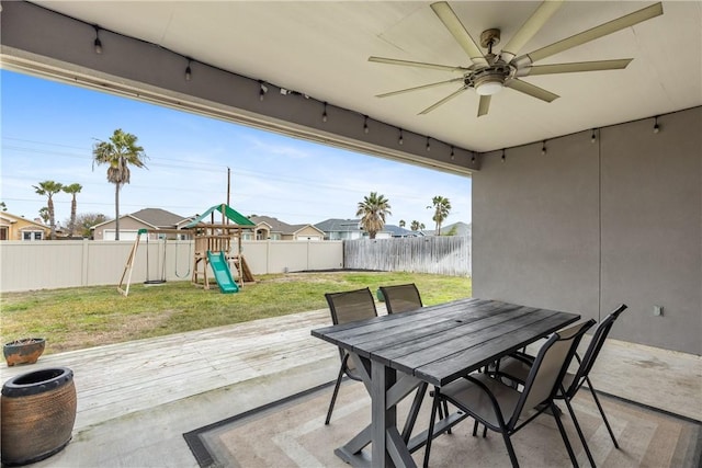 view of patio with ceiling fan and a playground