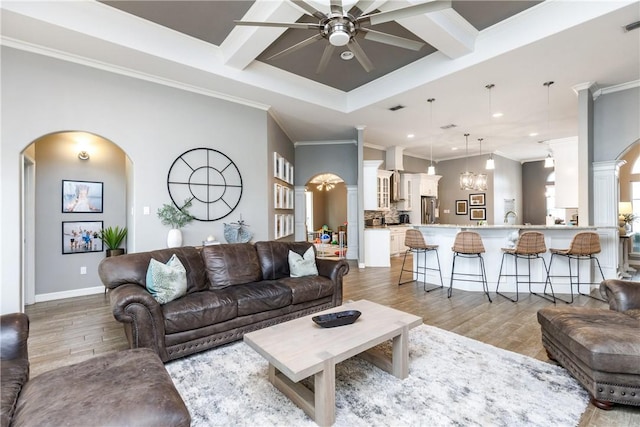 living room with coffered ceiling, ceiling fan with notable chandelier, beam ceiling, and light hardwood / wood-style flooring