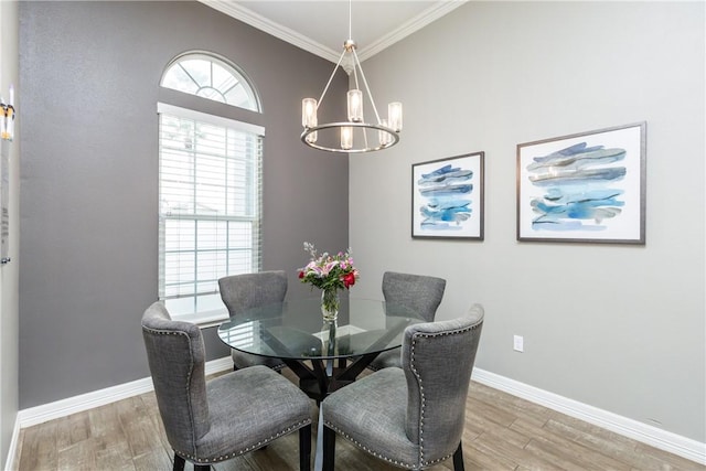 dining area with ornamental molding, wood-type flooring, and a chandelier