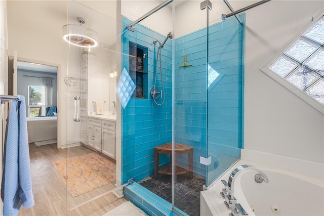 bathroom with shower with separate bathtub, vanity, and wood-type flooring