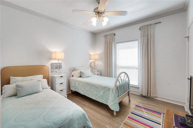 bedroom with light wood-type flooring, ceiling fan, and crown molding