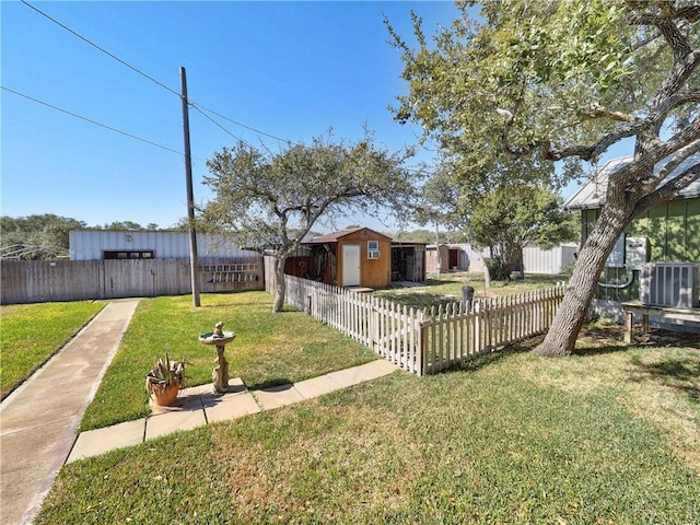 view of yard featuring fence private yard, an outdoor structure, and a shed