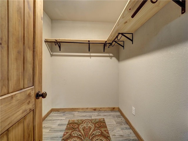 spacious closet with light wood finished floors