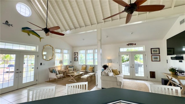 living area featuring french doors, light tile patterned flooring, visible vents, and a healthy amount of sunlight