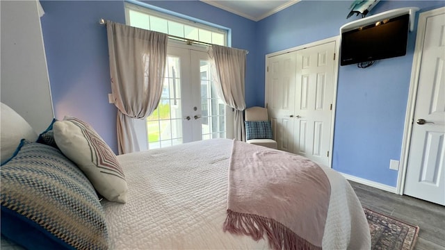 bedroom featuring baseboards, ornamental molding, wood finished floors, french doors, and a closet