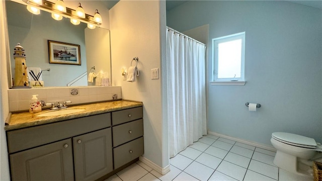 bathroom with tasteful backsplash, baseboards, toilet, tile patterned flooring, and vanity