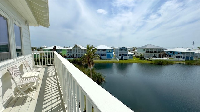 balcony with a water view and a residential view