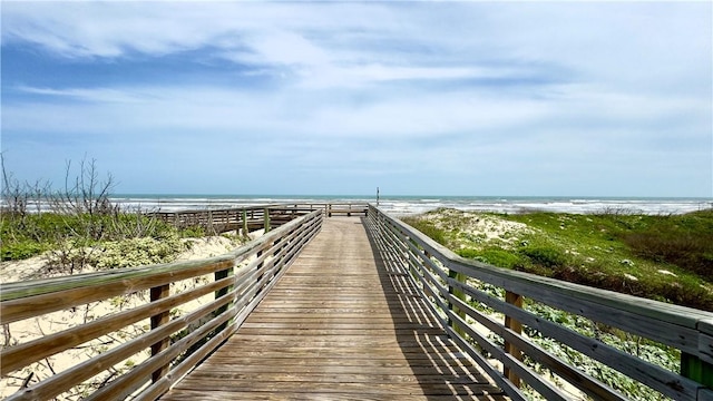 view of home's community with a water view and a view of the beach