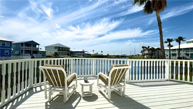 wooden deck with a water view and a residential view