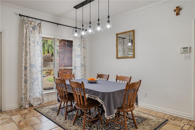 dining area featuring ornamental molding and light tile patterned floors