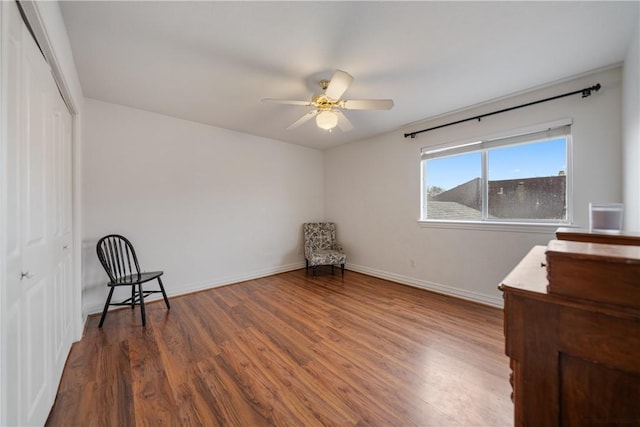 unfurnished room with ceiling fan and dark wood-type flooring