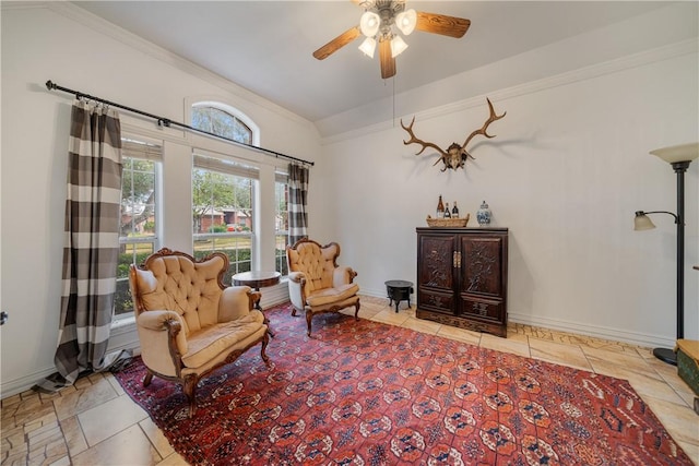 sitting room featuring ceiling fan, ornamental molding, and lofted ceiling