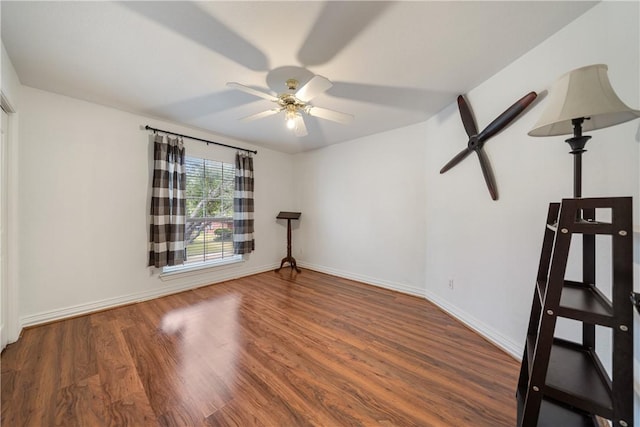 empty room with hardwood / wood-style floors and ceiling fan