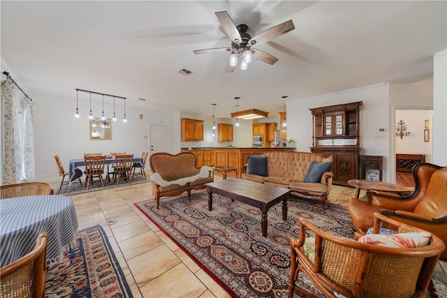 living room with ceiling fan and light tile patterned floors