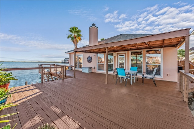 wooden terrace featuring a water view