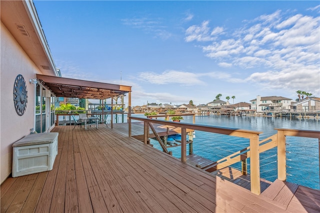 view of dock with a deck with water view