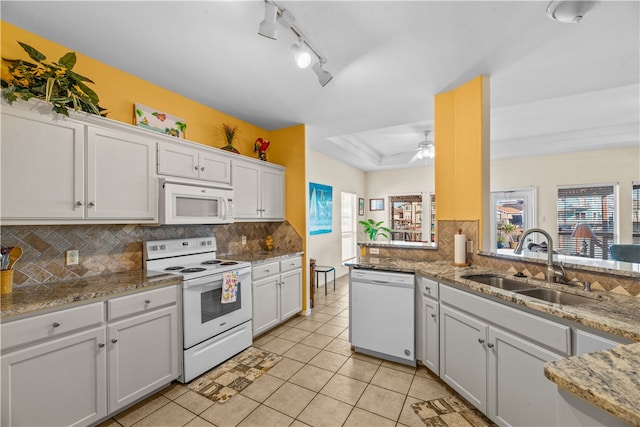 kitchen with white cabinets, sink, and white appliances