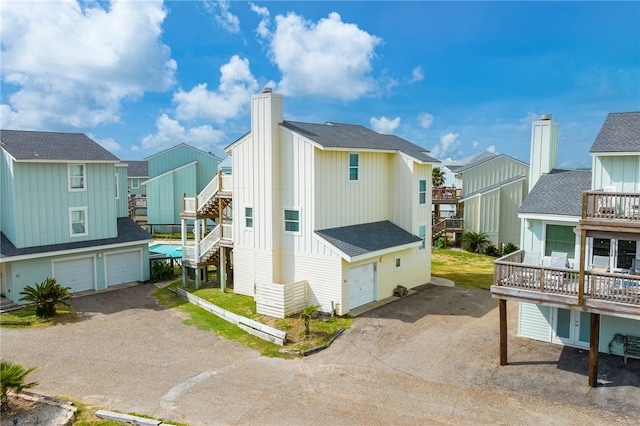 exterior space featuring a garage and a balcony