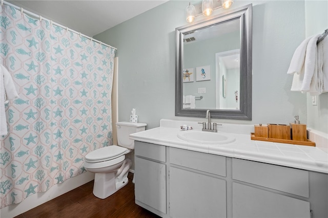 bathroom with hardwood / wood-style floors, vanity, and toilet