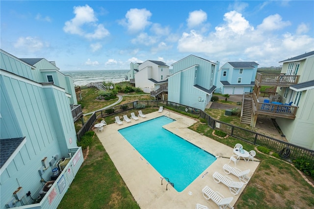 view of pool featuring a water view and a patio area