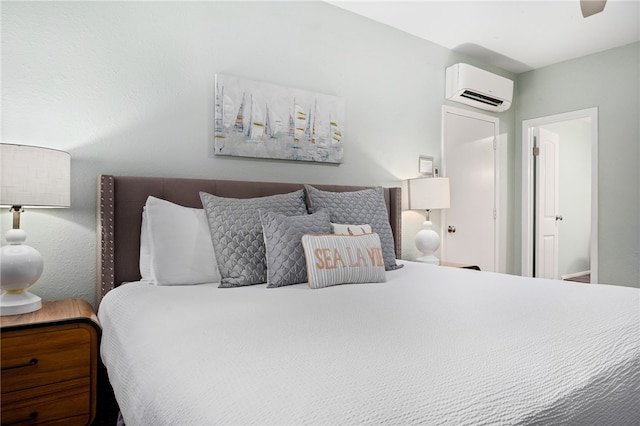 bedroom featuring a wall unit AC and ceiling fan