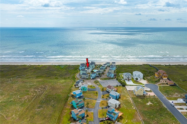 drone / aerial view featuring a water view and a beach view