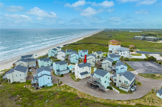 drone / aerial view featuring a beach view and a water view