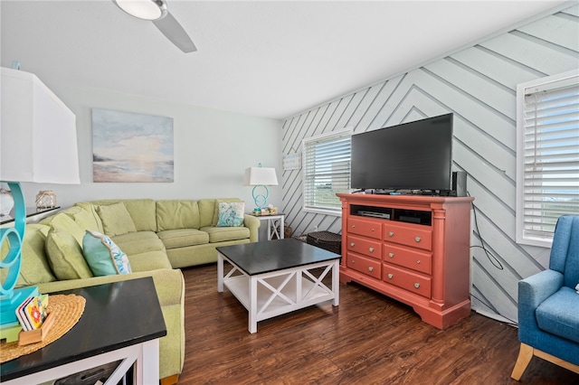 living room featuring ceiling fan and dark hardwood / wood-style floors