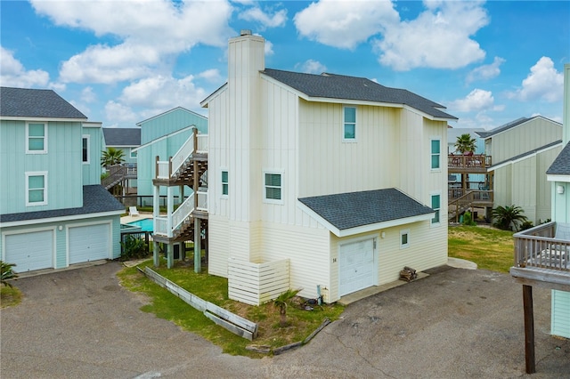 rear view of property with a garage