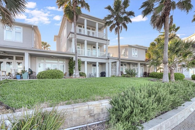 view of front of house featuring a front yard and a balcony